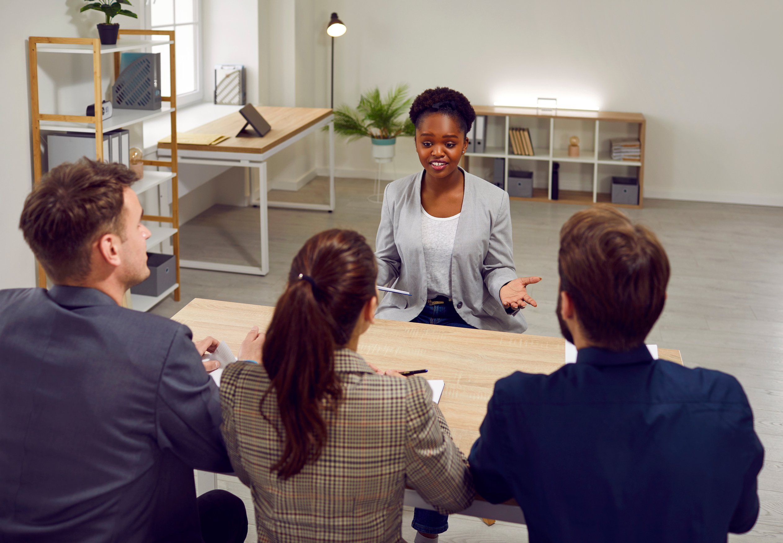 Female Job Applicant Answers Questions from Employers during Interview at Recruitment Agency Office